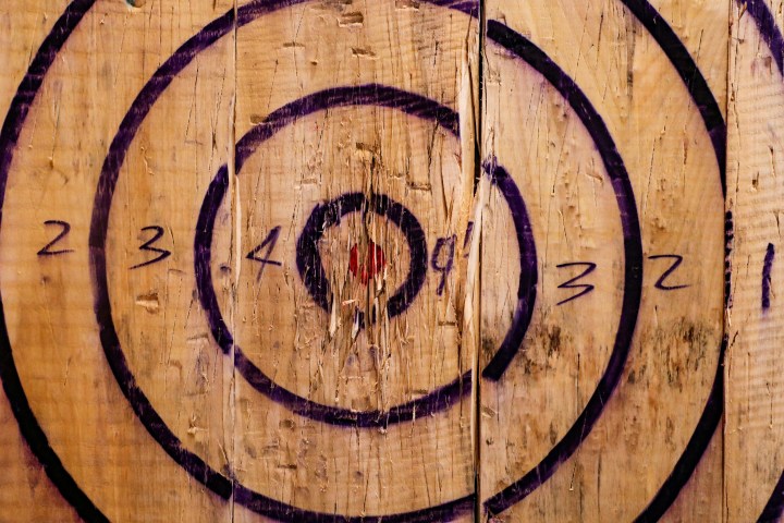 Wooden target with concentric circles and numbers for scoring.